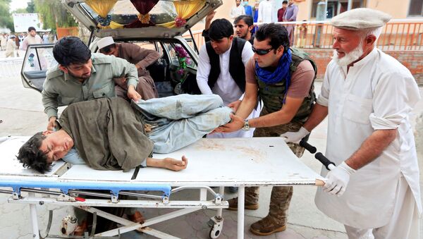 Men carry an injured person to a hospital after a bomb blast at a mosque, in Jalalabad, Afghanistan October 18, 2019 - Sputnik International
