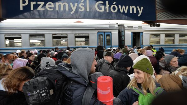 Ukrainian refugees wait on a platform upon arrival from Lvov at a railway station in Przemysl, the border control between Ukraine and Poland - Sputnik International