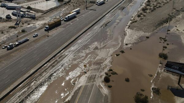 An aerial image shows traffic being diverted on Interstate 10 due to flooding and mud crossing the highway following heavy rains from Tropical Storm Hilary, in Rancho Mirage, California, on August 21, 2023. - Sputnik International
